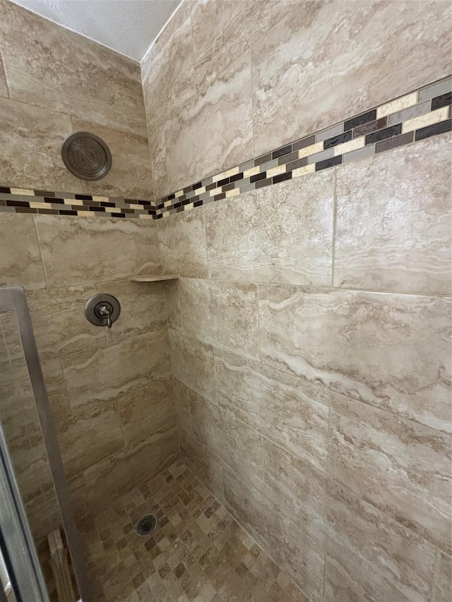 bathroom with tiled shower