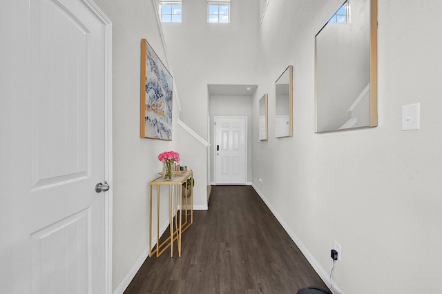 corridor with dark hardwood / wood-style flooring