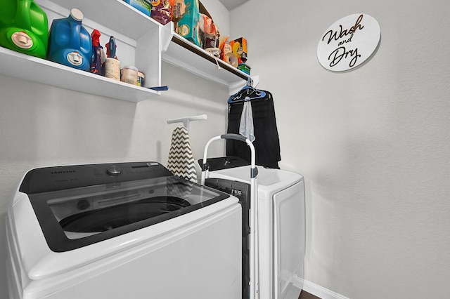 clothes washing area with separate washer and dryer