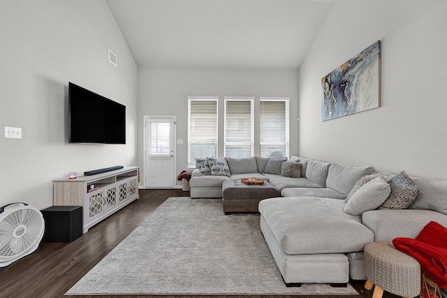 living room featuring dark hardwood / wood-style flooring and vaulted ceiling