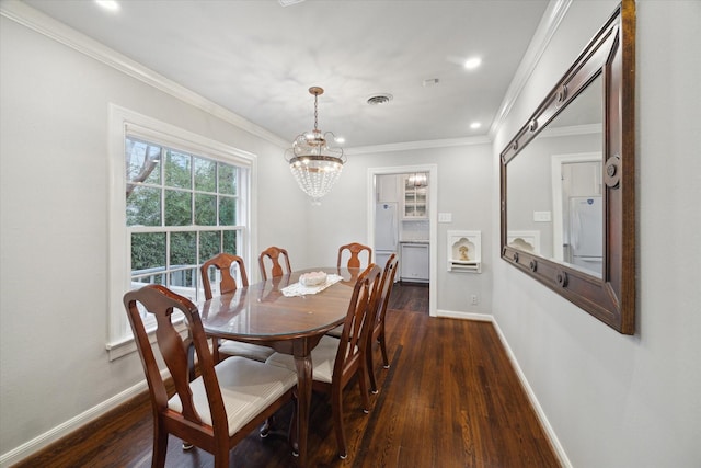 dining space featuring ornamental molding, dark hardwood / wood-style flooring, and a chandelier