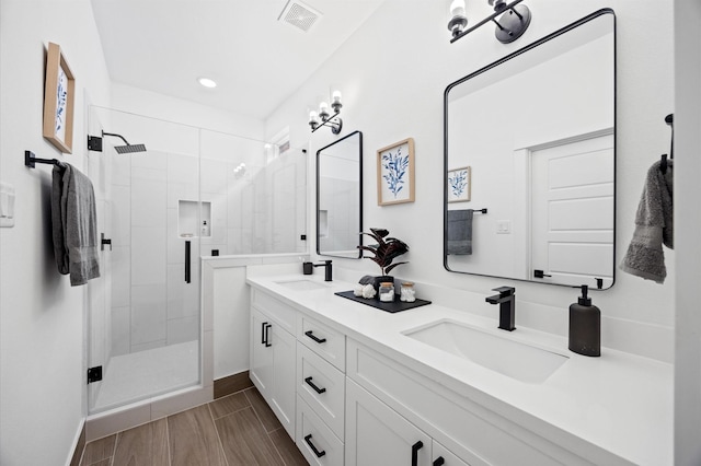 324 Neyland St, Houston, TX 77022 - full bathroom with a shower stall, double vanity, baseboards, and recessed lighting