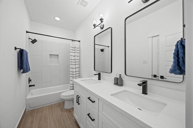 324 Neyland St, Houston, TX 77022 - full bathroom with toilet, double vanity, shower / bath combo, baseboards, and wood finished floors