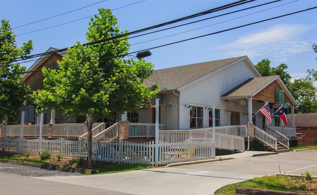 324 Neyland St, Houston, TX 77022 - view of front of property with covered porch, a fenced front yard, and roof with shingles