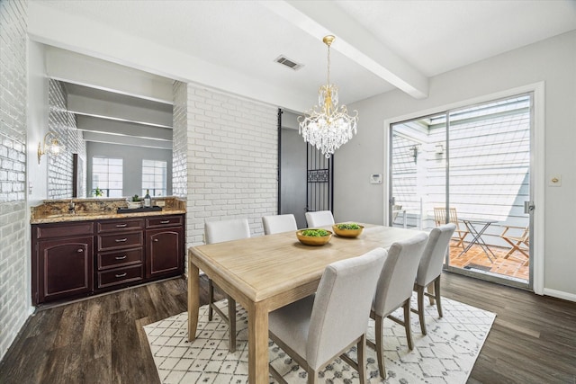 dining area featuring dark wood-type flooring, brick wall, beam ceiling, and an inviting chandelier