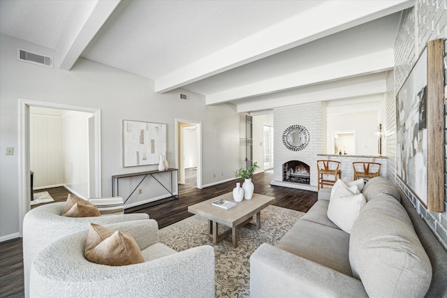 living room featuring a brick fireplace, dark wood-type flooring, and beamed ceiling