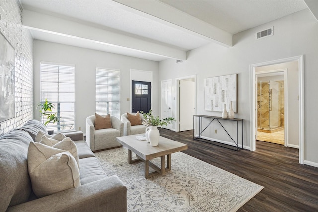 living room with beam ceiling, dark hardwood / wood-style floors, and a healthy amount of sunlight