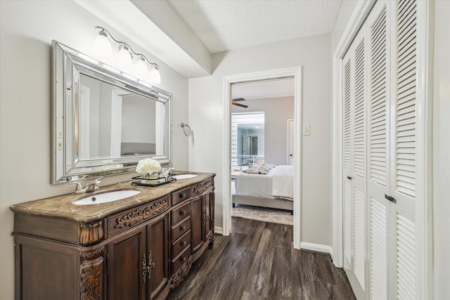 bathroom featuring vanity, hardwood / wood-style floors, and a textured ceiling