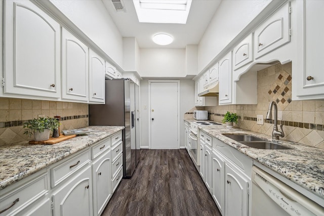 kitchen featuring sink, a skylight, dark hardwood / wood-style flooring, white appliances, and white cabinets