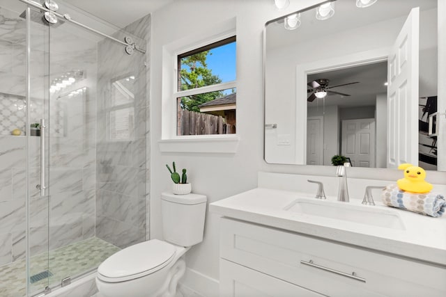 bathroom featuring walk in shower, ceiling fan, vanity, and toilet