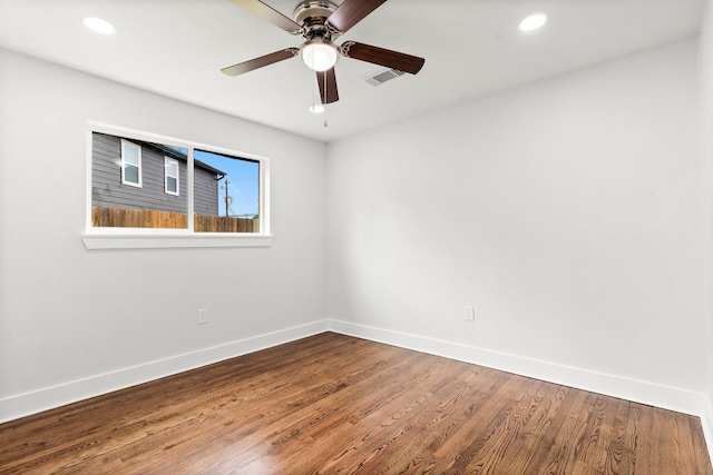 spare room featuring hardwood / wood-style floors and ceiling fan