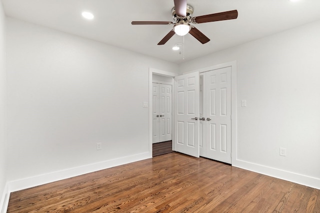 unfurnished bedroom with hardwood / wood-style flooring, ceiling fan, and a closet