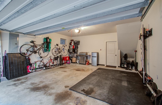 garage featuring stainless steel refrigerator and electric panel