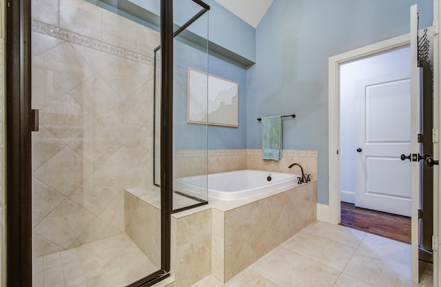 bathroom featuring tile patterned flooring and shower with separate bathtub