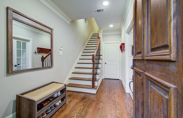 foyer featuring crown molding and dark hardwood / wood-style floors