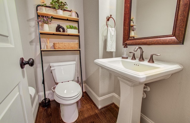 bathroom with sink, hardwood / wood-style flooring, and toilet