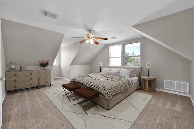 bedroom featuring lofted ceiling, light colored carpet, and ceiling fan