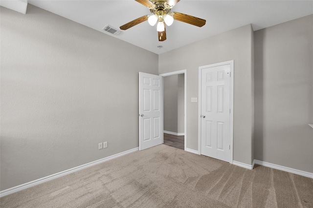 unfurnished bedroom featuring carpet floors and ceiling fan