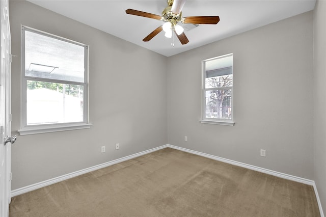 empty room featuring light carpet and ceiling fan