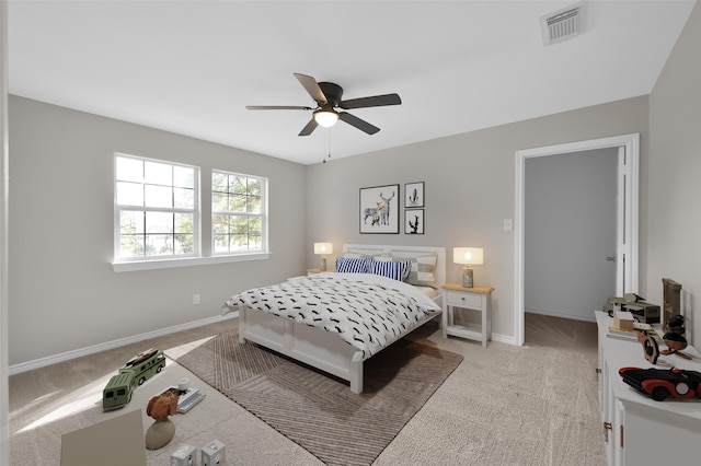 bedroom with light carpet and ceiling fan