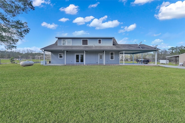 view of front facade with french doors, a carport, and a front lawn