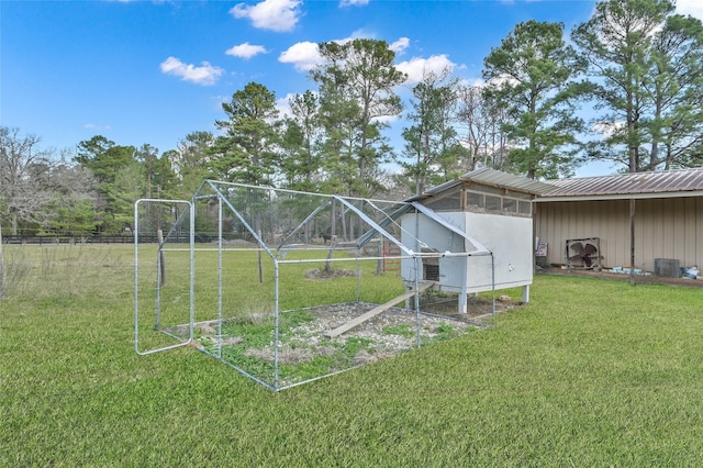 view of yard with an outdoor structure and central air condition unit