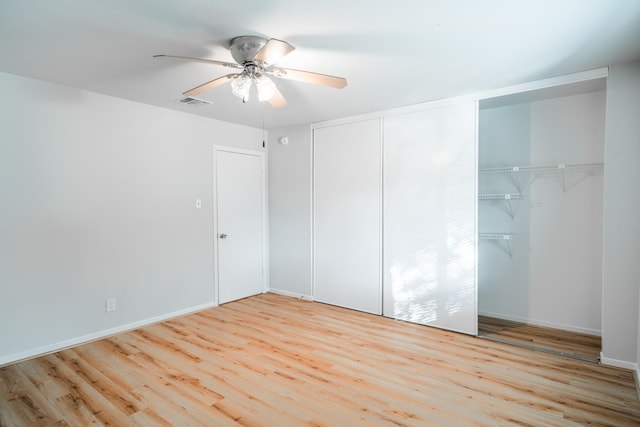 unfurnished bedroom with ceiling fan, light hardwood / wood-style floors, and a closet