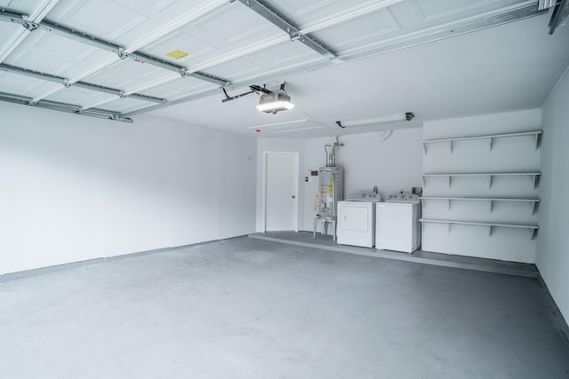 garage with a garage door opener, gas water heater, and washer and clothes dryer