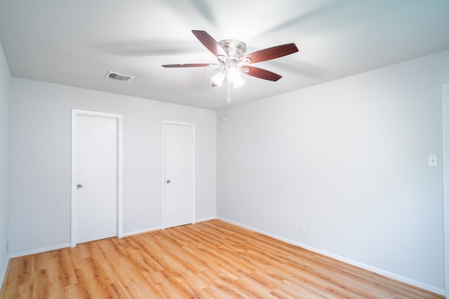 unfurnished bedroom with ceiling fan and light hardwood / wood-style floors