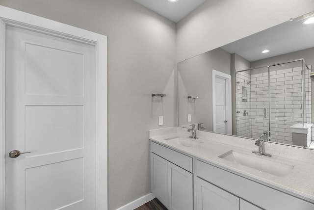 bathroom with vanity, a shower with door, and hardwood / wood-style floors