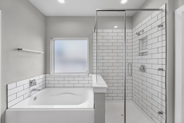 bathroom with shower with separate bathtub