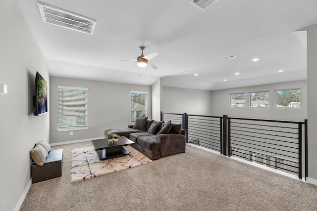 carpeted living room with ceiling fan