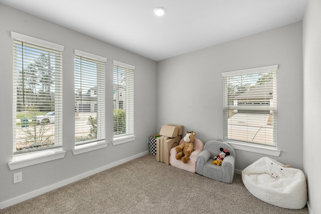 playroom featuring baseboards and carpet