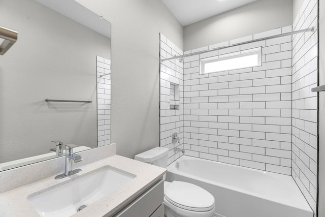 full bathroom with tiled shower / bath combo, vanity, and toilet