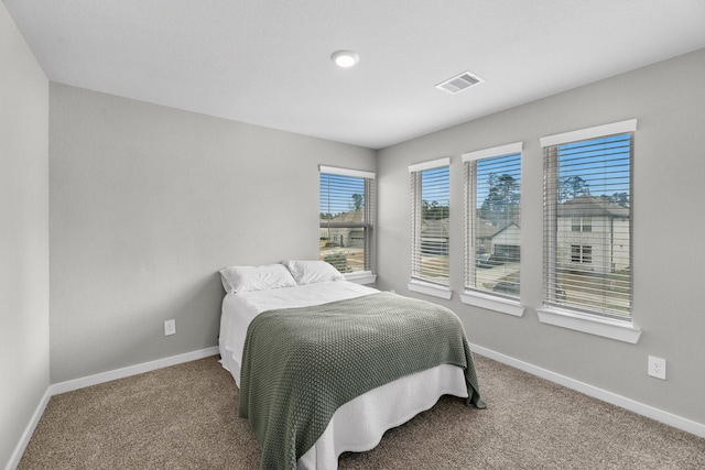 bedroom with visible vents, baseboards, and carpet floors