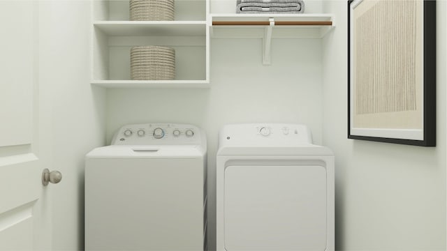 clothes washing area with washing machine and dryer