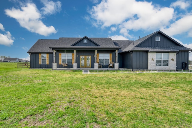 view of front of home featuring a front lawn and french doors