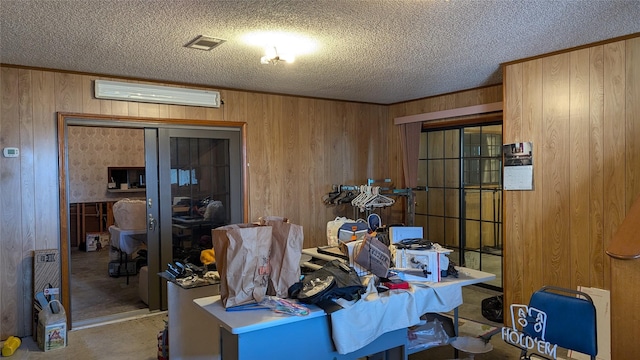 interior space with wooden walls and a textured ceiling