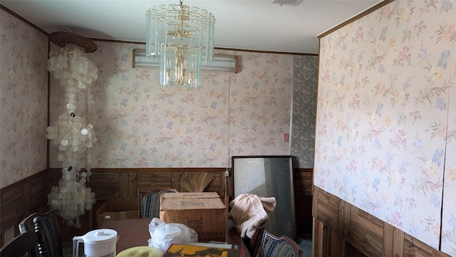 unfurnished dining area with ornamental molding and a textured ceiling