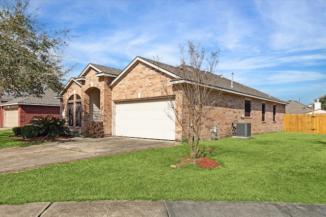 ranch-style house featuring a garage, a front lawn, and central air condition unit