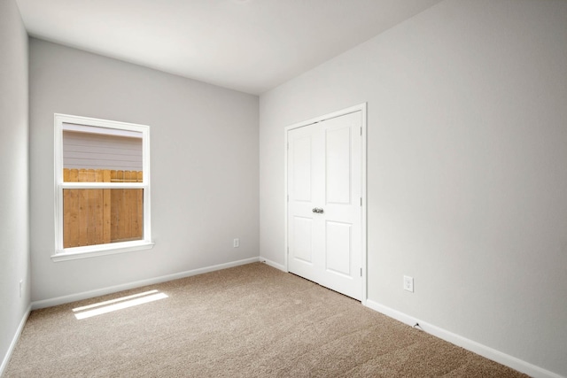 unfurnished bedroom with carpet floors and a closet