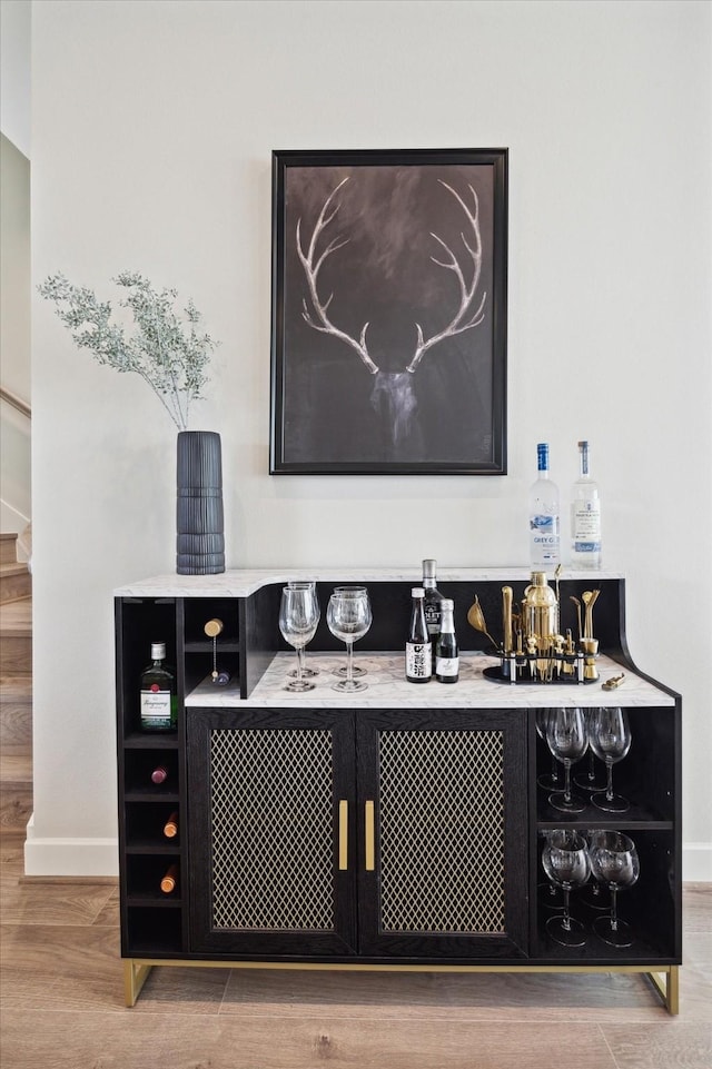 bar with wood-type flooring