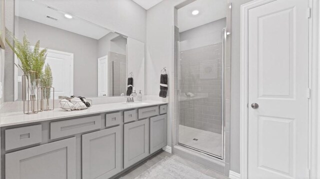 bathroom featuring vanity and an enclosed shower