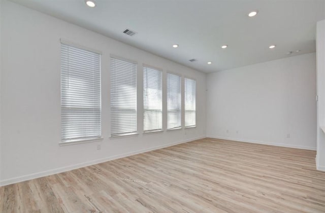 spare room with baseboards, recessed lighting, visible vents, and light wood-style floors