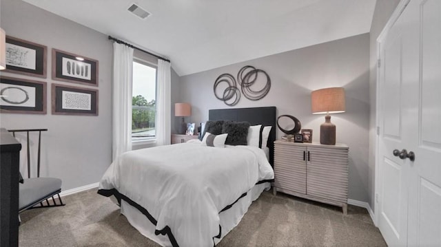 carpeted bedroom featuring visible vents, vaulted ceiling, and baseboards