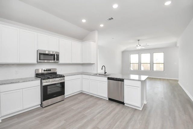 kitchen with white cabinetry, kitchen peninsula, and appliances with stainless steel finishes