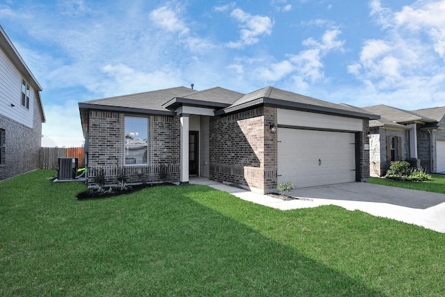 view of front of house featuring a garage, a front lawn, and central air condition unit