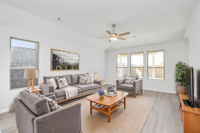 living room featuring hardwood / wood-style floors and ceiling fan