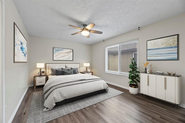 bedroom with ceiling fan, radiator, dark hardwood / wood-style floors, and a textured ceiling