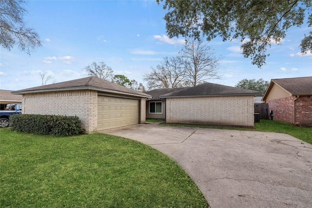 ranch-style house featuring a garage and a front lawn